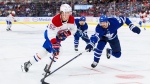 Montreal Canadiens' Justin Barron (52) skates the puck around Toronto Maple Leafs' Oliver Ekman-Larsson (95) during third period pre-season NHL hockey action in Toronto on Thursday, September 26, 2024. The Montreal Canadiens have traded defenceman Justin Barron to the Nashville Predators in exchange for blueliner Alexandre Carrier. (The Canadian Press/Cole Burston)