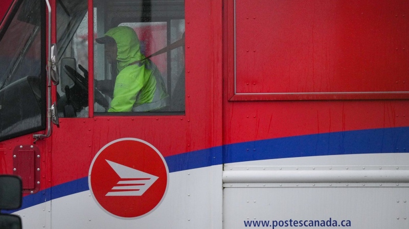 A Canada Post employee drives a mail truck at a delivery depot in Vancouver on Tuesday, Dec. 17, 2024. THE CANADIAN PRESS/Darryl Dyck