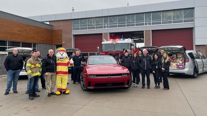 Crews with Windsor Fire and Rescue Services Station No. 5, Stellantis Windsor Assembly Plant Manager, David Bellaire, plant employees and members of Unifor 444 deliver donations for Sparky's Toy Drive. Dec. 18, 2024. (Meagan Delaurier/AM800 News)