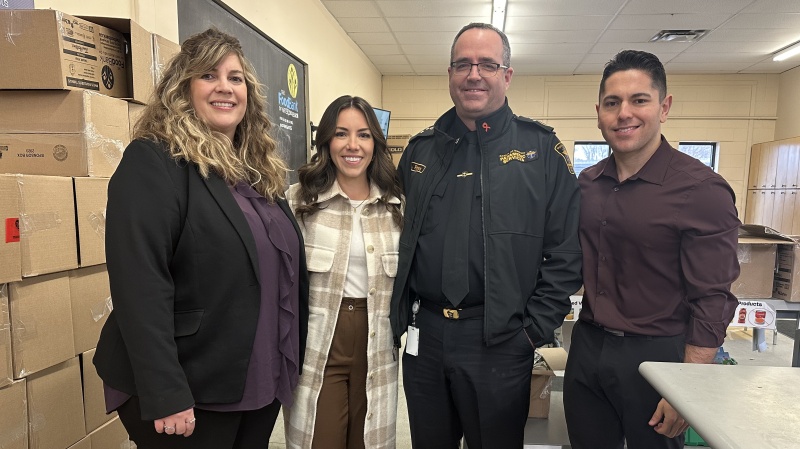 Kim Wilhelm of the Food Bank of Waterloo Region , Leighanne Evans, Paramedic Services Chief John Riches, and Tyler Kelaher on Dec. 19, 2024.