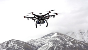 In this Feb. 13, 2014 file photo, members of the Box Elder County Sheriff's Office fly their search and rescue drone during a demonstration, in Brigham City, Utah. Gov. Gary Hebert has approved the state's first drone restrictions, setting new limits on law enforcement's use of the technology. Herbert's office announced Wednesday that he signed the legislation, which supporters say is needed as drone technology advances and becomes more widespread. (AP Photo/Rick Bowmer, File)