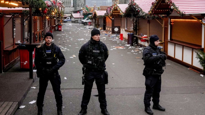 Policemen guard a Christmas Market, where a car drove into a crowd on Friday evening, in Magdeburg, Germany, Saturday, Dec. 21, 2024. (AP Photo/Michael Probst)