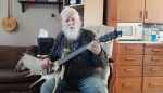 Lorne Collie holds a guitar made from a moose antler at his home in Hope, B.C. in this Wednesday, Dec. 18, 2024, handout photo. THE CANADIAN PRESS/HO, James Collie 