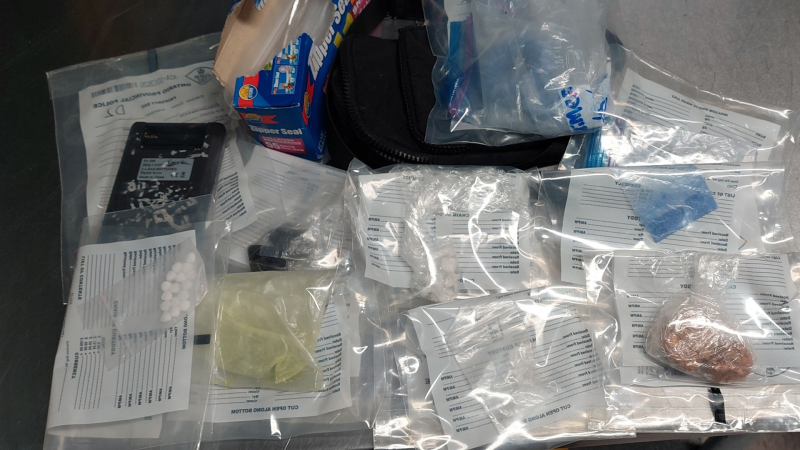 A wanted eastern Ontario man was located by chance with $50,000 worth of drugs and cash on him in a home in eastern Ontario Friday morning, according to the Ontario Provincial Police (OPP).