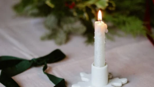 An undated stock image of a candle on a decorated table. (Nati/Pexels)