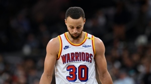 Golden State Warriors guard Stephen Curry walks upcourt during the second half of an NBA basketball game against the San Antonio Spurs, Saturday, Nov. 23, 2024, in San Antonio. (AP Photo/Darren Abate)