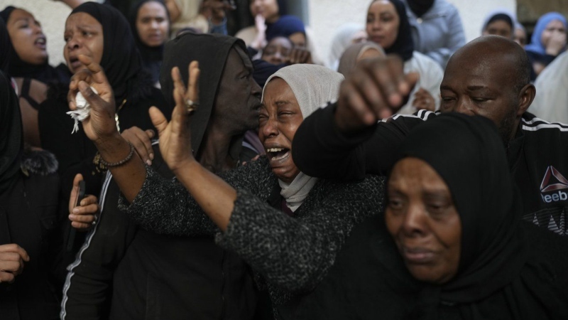 Mourners cry while they take the last look at the body of a relative, one of eight Palestinians killed, during their funeral following the withdrawal of the Israeli army, in the West Bank city of Tulkarem, Thursday, Dec. 26, 2024. (Matias Delacroix/AP Photo)