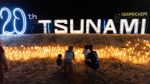 Relatives of victims of the 2004 Indian Ocean tsunami hold a candlelight vigil as they participate on the 20th anniversary, at Tsunami Memorial Park at Ban Nam Khem, Takuapa district of Phang Nga province, southern Thailand, Thursday, Dec. 26, 2024. (AP Photo/Wason Wanichakorn)