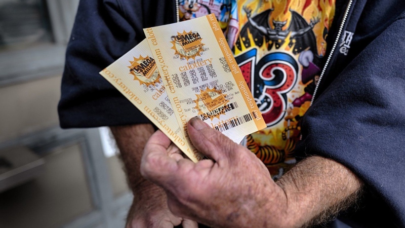 Dennis Murphy shows off his lottery tickets he just bought at Joe's Service Center on Friday, Dec. 27, 2024 in Altadena, Calif. In 2022, the location had sold a $2.04 billion Powerball ticket. (AP Photo/Richard Vogel)