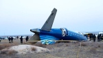 A part of Azerbaijan Airlines' Embraer 190 lies on the ground near the airport of Aktau, Kazakhstan, on Thursday, Dec. 26, 2024. (The Administration of Mangystau Region via AP)