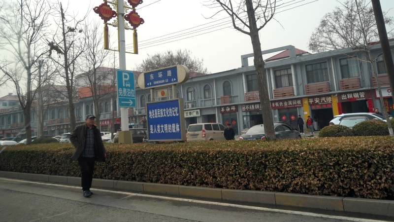 A man walks along the road in the city of Handan in northern China's Hebei province on Feb. 28, 2024. 