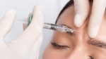 A woman receives an injection in her forehead in a Shutterstock image. 