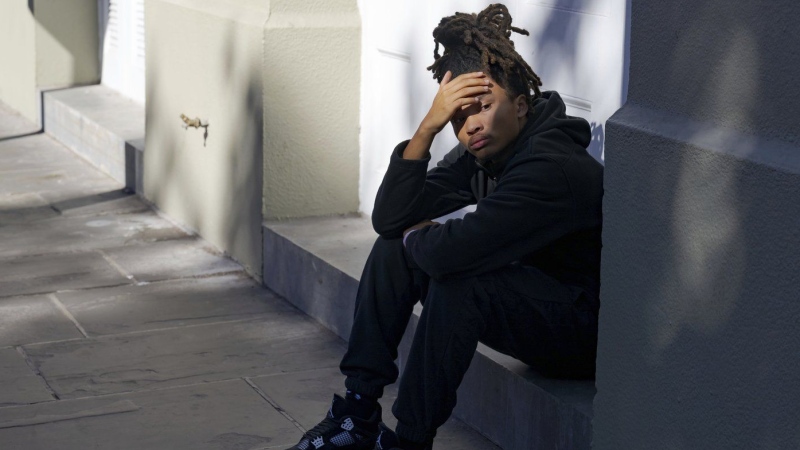 Trevant Hayes, 20, sits in the French Quarter after the death of his friend, Nikyra Dedeaux, 18, after a pickup truck crashed into pedestrians on Bourbon Street followed by a shooting in the French Quarter in New Orleans, Wednesday, Jan. 1, 2025. (AP Photo/Matthew Hinton)