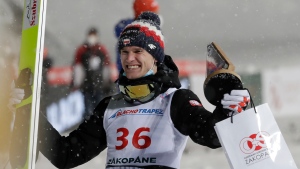 Second placed Andrzej Stekala of Poland celebrates during the award ceremony at the FIS Ski Jumping World Cup in Zakopane, Poland, Saturday, Feb. 13, 2021. (AP Photo/Czarek Sokolowski)