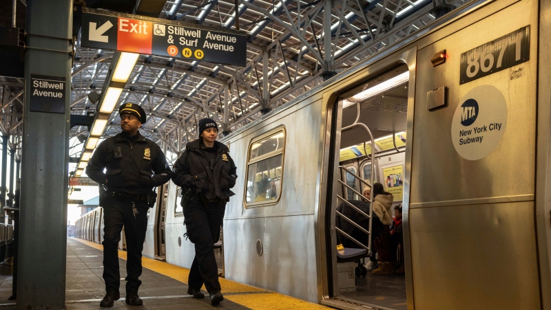 Police officers patrol the F train platform at the Coney Island-Stillwell Avenue Station, Thursday, Dec. 26, 2024, in New York. (AP Photo/Yuki Iwamura)
