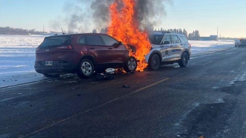 A RCMP cruiser and a fleeing vehicle catch fire on Dec. 24, 2024. (Manitoba RCMP)