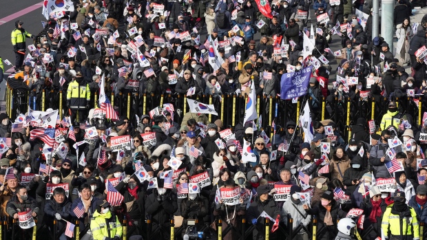 Supporters of impeached South Korean President Yoon Suk Yeol stage a rally to oppose a court having issued a warrant to detain Yoon, near the presidential residence in Seoul, South Korea, Friday, Jan. 3, 2025. The letters read, "Oppose Impeachment." (AP Photo/Lee Jin-man)