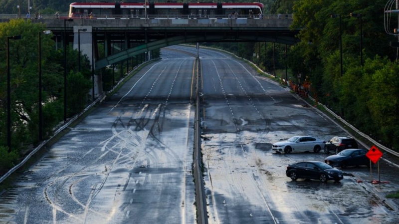 Cars remain stranded on the Don Valley Parkway as water recedes following heavy rain that caused flooding in Toronto on July 16, 2024. THE CANADIAN PRESS/Christopher Katsarov