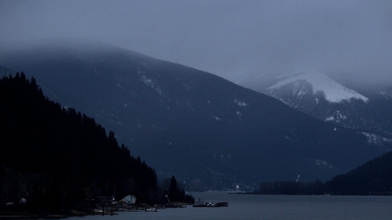 Kokanee Glacier, right, is pictured shrouded by low cloud above Kootenay Lake north of Nelson, B.C., Jan. 17, 2011. (Darryl Dyck / The Canadian Press)