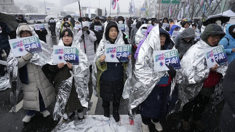 Banners read "Disband the ruling People Power Party" and "Arrest Yoon Suk Yeol," in Seoul, South Korea, Sunday, Jan. 5, 2025.  (AP Photo/Ahn Young-joon)