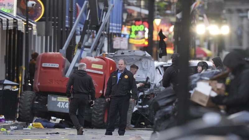 Emergency services attend the scene on Bourbon Street after a vehicle drove into a crowd on New Orleans' Canal and Bourbon Street, Wednesday Jan. 1, 2025. (AP Photo/Gerald Herbert)