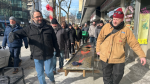 "Crawl bearers" carry Phog Lounge's 400-pound mosaic bar top through downtown Windsor, Ont. on Jan. 5, 2025. (Robert Lothian/CTV News Windsor)