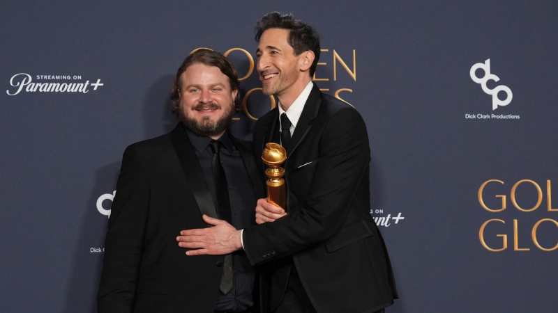 Brady Corbet, winner of the award for best director - motion picture for "The Brutalist," left, and Adrien Brody, winner of the award for best performance by a male actor in a motion picture - drama for "The Brutalist," pose in the press room during the 82nd Golden Globes, Jan. 5, 2025, at the Beverly Hilton in Beverly Hills, Calif. (AP Photo/Chris Pizzello)