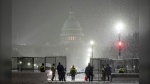 Law enforcement officers stand guard at the Capitol as snow falls in Washington on Jan. 6, 2025. (Matt Rourke / AP Photo)
