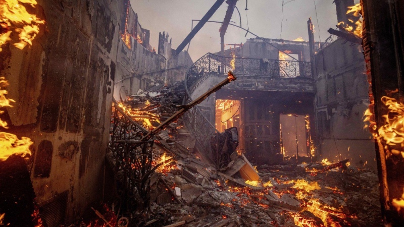 The Palisades Fire burns a residence in the Pacific Palisades neighborhood of Los Angeles, Tuesday, Jan. 7, 2025. (Ethan Swope / The Associated Press)
