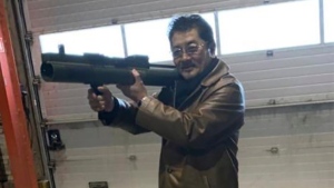 Takeshi Ebisawa handling a rocket launcher. Federal prosecutors say the leader of a Japan-based crime syndicate conspired to traffic uranium and plutonium from Myanmar in the belief that Iran would use it for nuclear weapons. (U.S. Attorney, Southern District of New York via AP)