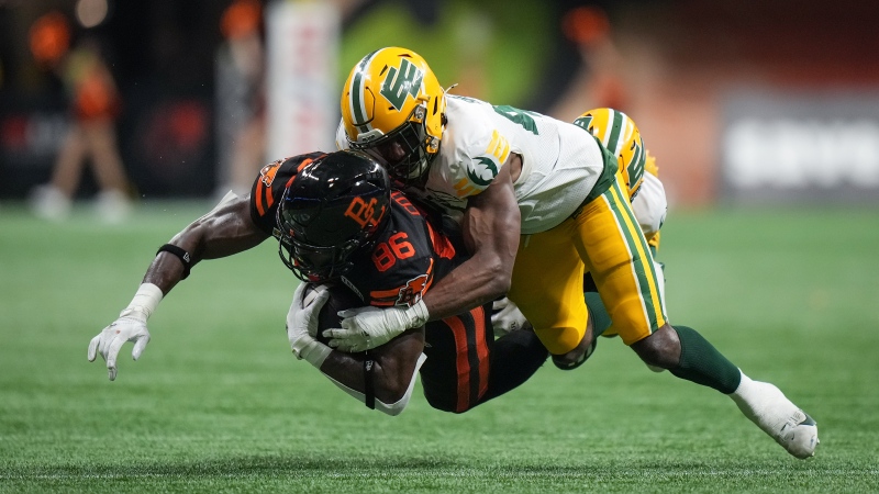 B.C. Lions' Jevon Cottoy (86) is tackled by Edmonton Elks' Elliott Brown, front right, and Devodric Bynum, back, after making a reception during the second half of a CFL football game, in Vancouver, on Thursday, June 27, 2024. (Darryl Dyck / The Canadian Press) 