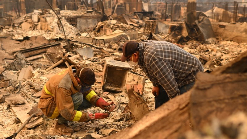 Robert Lara, left, looks for belongings along with his stepfather after the Eaton Fire burns in Altadena, Calif., Thursday, Jan. 9, 2025. (Nic Coury / AP Photo)