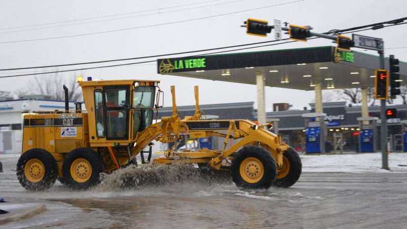 Slush is plowed on a street during a winter storm, Thursday, Jan. 9, 2025, in Arlington, Texas. (AP Photo/Julio Cortez)