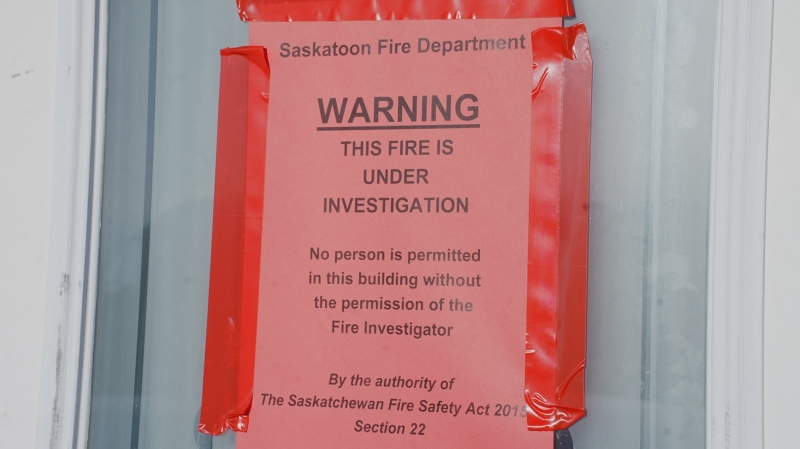 A sign from the Saskatoon Fire Department has been taped to the front of the home destroyed by flames on Jan. 3. (Laura Woodward/CTV News) 