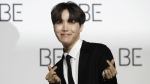 J-Hope, a member of South Korean K-pop band BTS poses for photographers during a press conference to introduce their new album "BE" in Seoul, South Korea, Nov. 20, 2020. (AP Photo/Lee Jin-man)