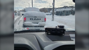 A pickup truck covered in snow caught charges from police (Source: London Police Service)