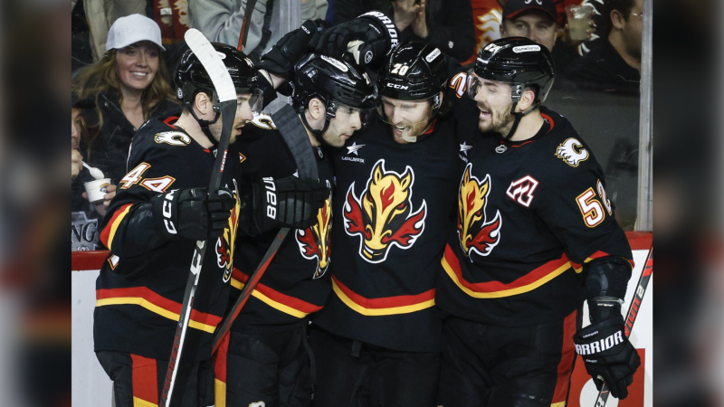 Calgary Flames' Matthew Coronato, second left, celebrates his goal with teammates during second period NHL hockey action against the Los Angeles Kings in Calgary on Saturday, Jan. 11, 2025.THE CANADIAN PRESS/Jeff McIntosh