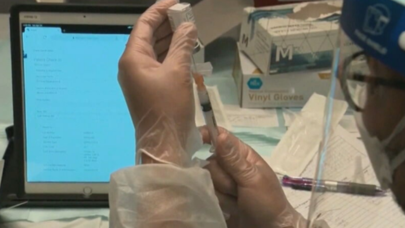 A practitioner prepares a vaccination for COVID-19, flu and RSV in this undated file image.