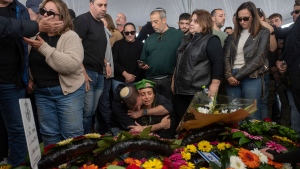 Gali, the mother of the Israeli soldier Sgt. Yahav Maayan, who was killed in combat in the Gaza Strip, reacts next to her son's grave during his funeral at a military cemetery in Modiin, Israel, Jan. 12, 2025. (AP Photo/Ohad Zwigenberg)