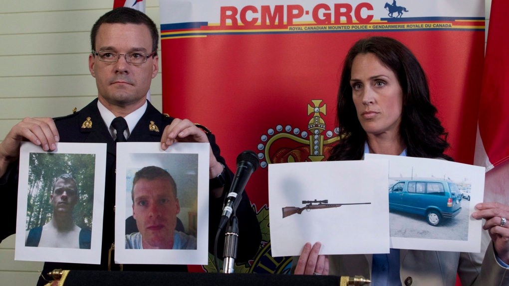 RCMP Insp. Tim Shields and Sgt. Jennifer Pound hold up photos of Angus David Mitchell