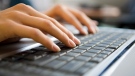 A person typing on their keyboard is seen in this file photo. 