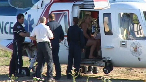 The mother of a toddler who nearly drowned in a Surrey, B.C., pool sits in an air ambulance waiting to transfer the girl. July 2, 2010. (CTV)