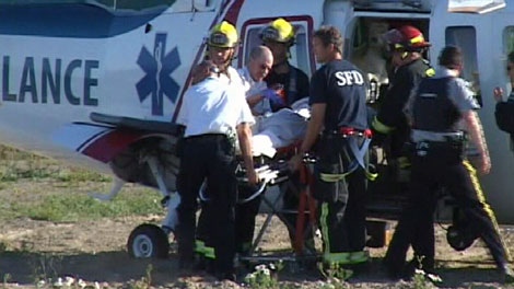 Paramedics transfer a toddler who nearly drowned in a Surrey, B.C., to an air ambulance. July 2, 2010. (CTV)