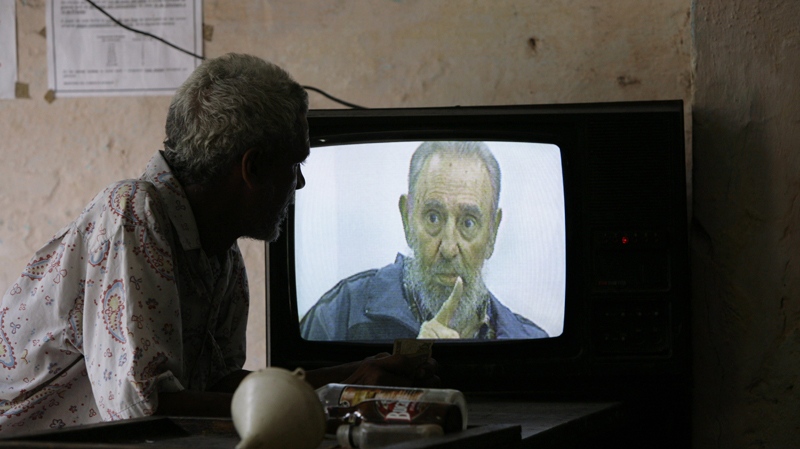 A man watches Cuba's leader Fidel Castro on a TV set, during an interview with Cubavision, on its talk show "Mesa Redonda" or "Round Table", in Havana, Monday, July 12, 2010. (AP / Franklin Reyes) 