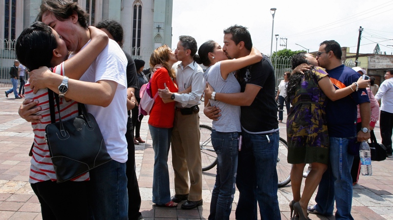 Manuel Berumen and his wife Mayra Alema, left, are accompanied by other couples as they hold a "kiss-in" protest in the city of Leon, Mexico, Sunday, Aug. 5, 2012. (AP)