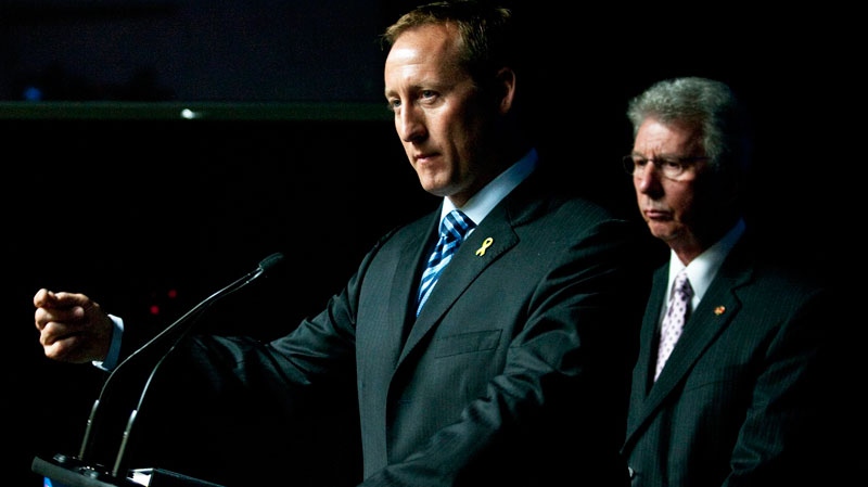 Minister of National Defence Peter MacKay gestures as Minister of Veteran Affairs Jean-Pierre Blackburn looks on during an announcement of $52.5 million over five years for support for injured Canadian Forces personnel and their families at the Department of National Defence headquarters in Ottawa on Tuesday, Sept. 28, 2010. (Pawel Dwulit / THE CANADIAN PRESS)